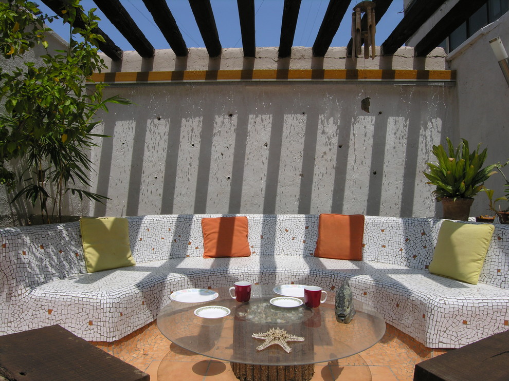 Photo of a beach style patio in Pune with a pergola.