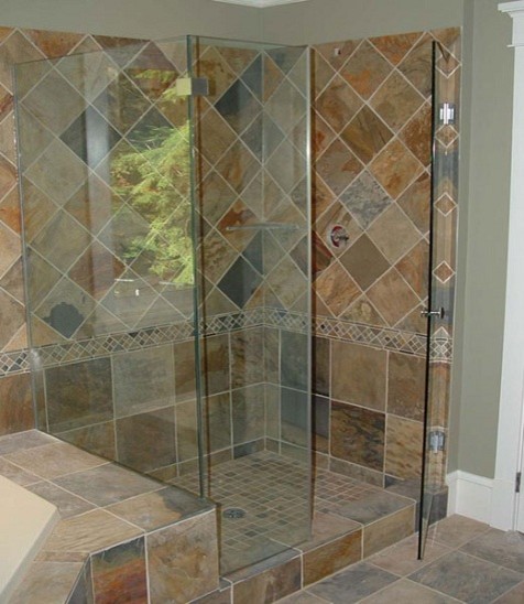 Mid-sized mediterranean bathroom in New York with a drop-in tub, a corner shower, brown tile, stone tile, grey walls and slate floors.
