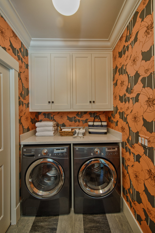 Photo of a mid-sized traditional laundry room in Portland with quartz benchtops, linoleum floors and a side-by-side washer and dryer.