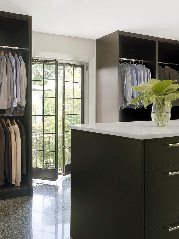 Design ideas for a mid-sized contemporary gender-neutral walk-in wardrobe in St Louis with black cabinets, flat-panel cabinets and ceramic floors.