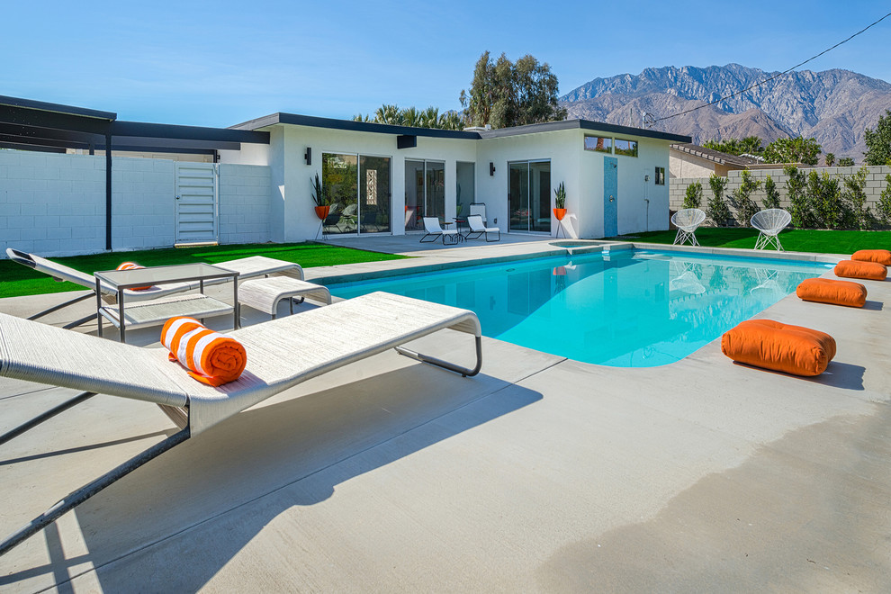 Design ideas for a midcentury rectangular pool in Other with concrete slab.