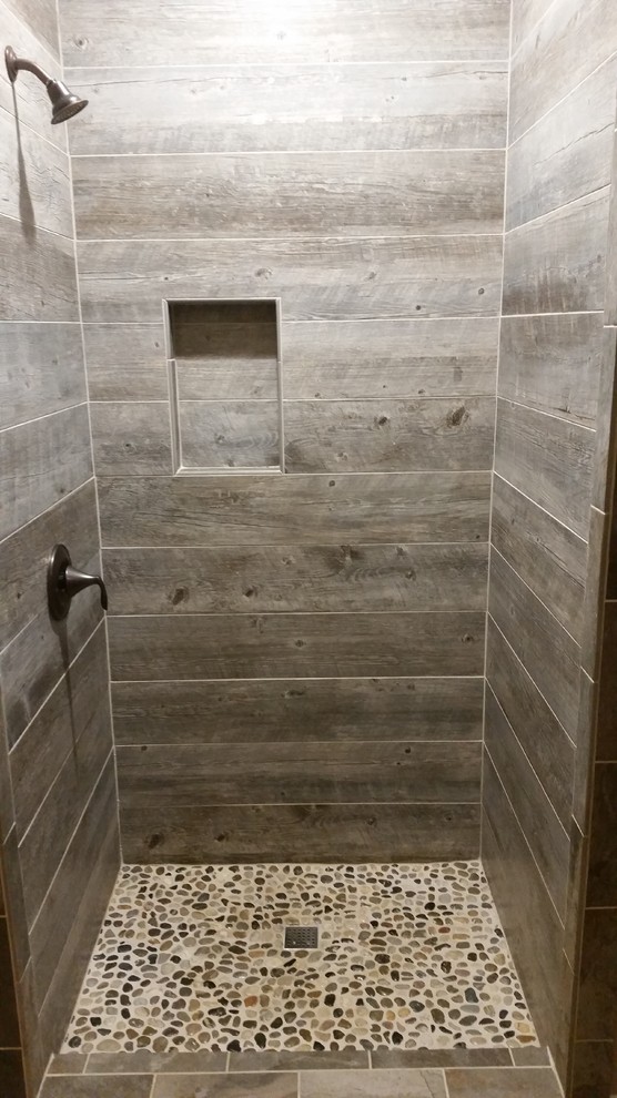 Photo of a country master bathroom in Other with an open shower, gray tile, ceramic tile and pebble tile floors.