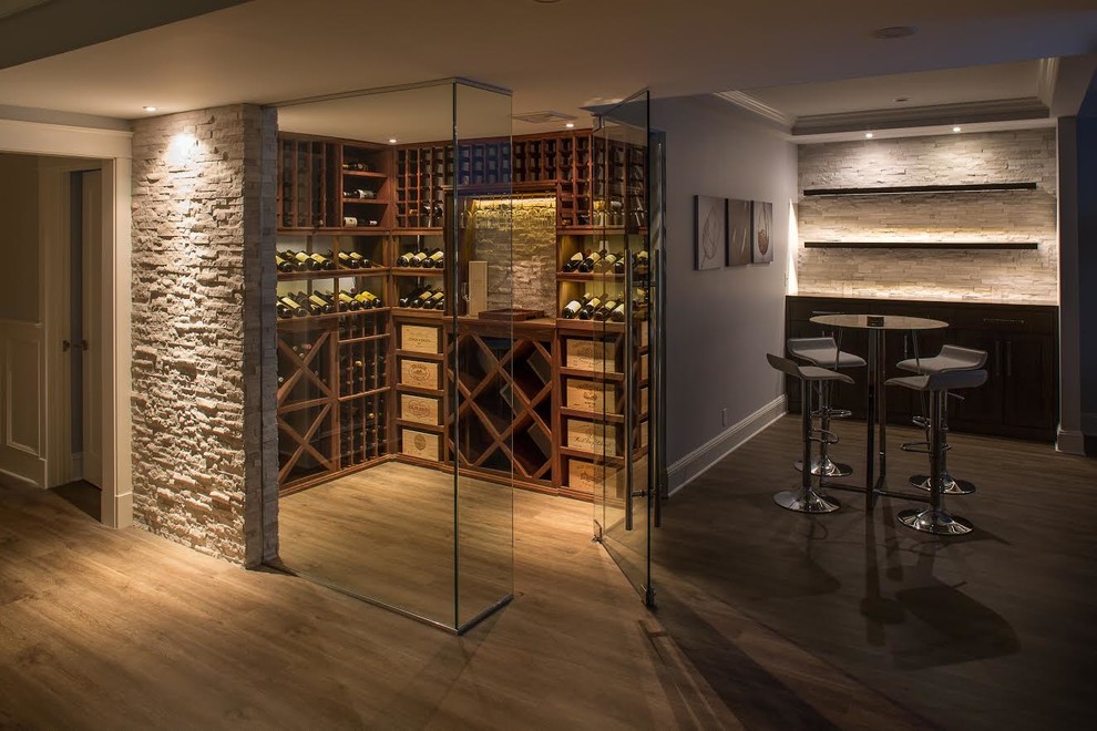 Photo of a mid-sized traditional wine cellar in New York with light hardwood floors, storage racks and brown floor.