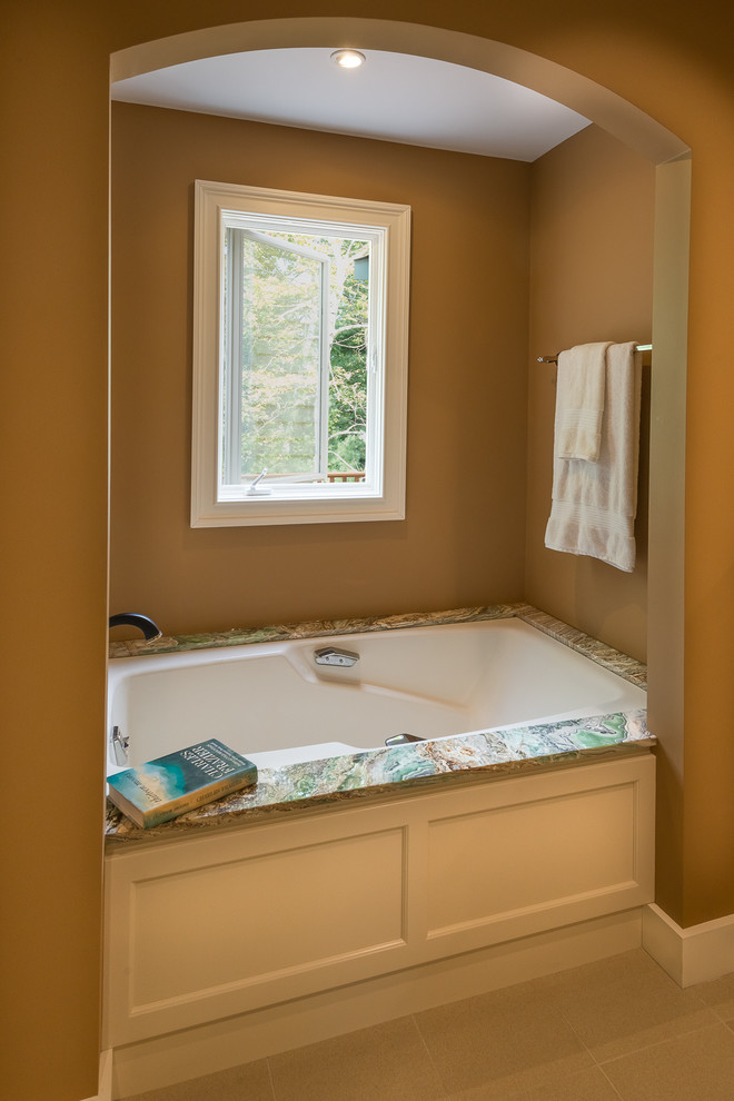 Inspiration for a mid-sized contemporary master bathroom in Boston with an undermount sink, recessed-panel cabinets, white cabinets, onyx benchtops, an undermount tub, a corner shower, a two-piece toilet, beige tile, porcelain tile, brown walls and porcelain floors.