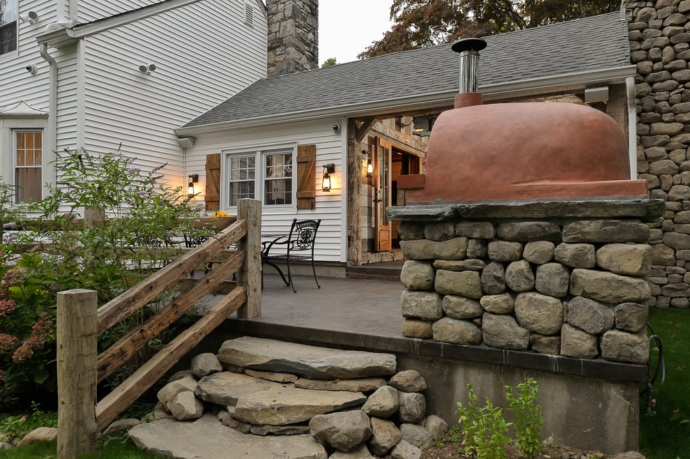 Inspiration for a mid-sized country backyard patio in New York with an outdoor kitchen, concrete slab and no cover.