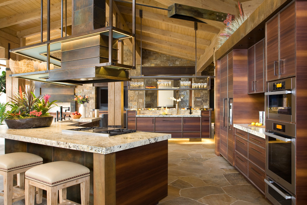 Photo of an expansive contemporary kitchen in Denver with flat-panel cabinets, dark wood cabinets and slate floors.