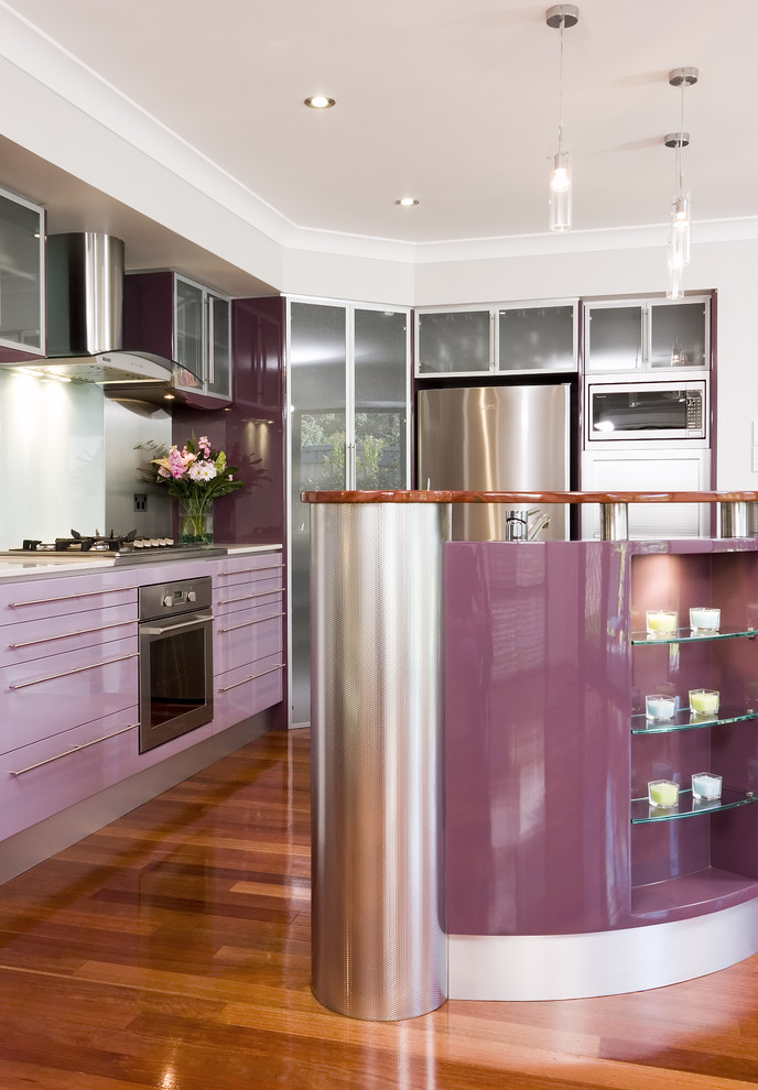 Photo of a contemporary kitchen in Brisbane with glass-front cabinets and stainless steel appliances.