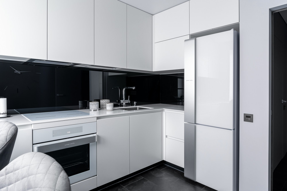 Idéer för att renovera ett mellanstort funkis vit vitt kök, med en undermonterad diskho, släta luckor, vita skåp, bänkskiva i kvarts, svart stänkskydd, vita vitvaror, vinylgolv och svart golv