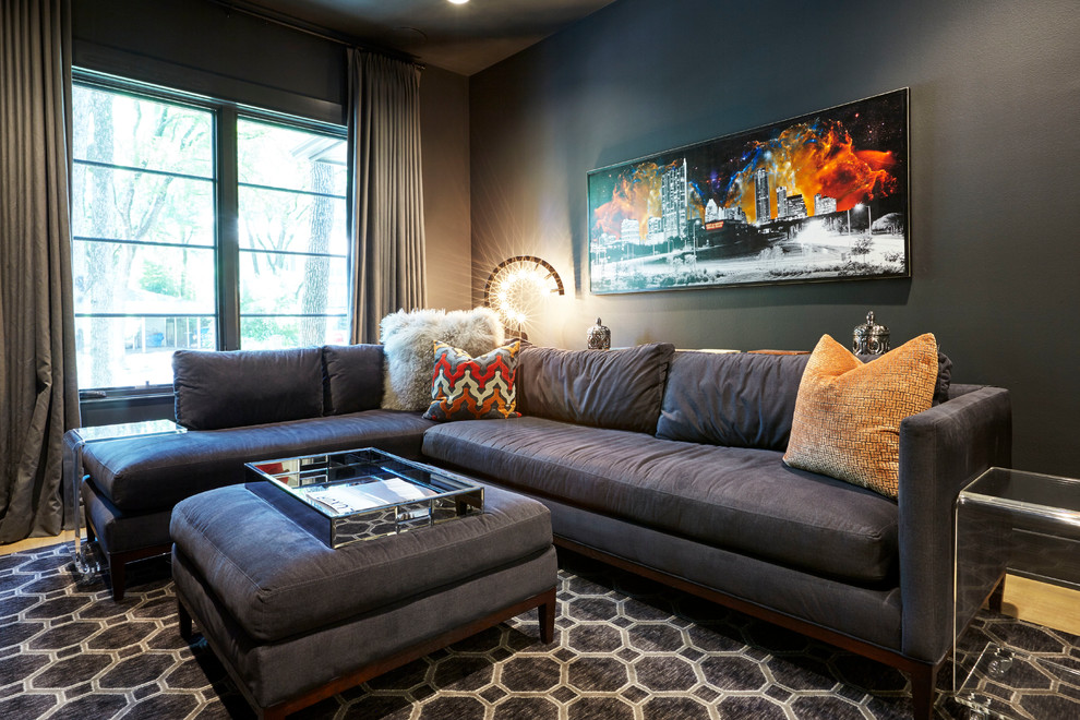 Design ideas for a contemporary living room in Austin with black walls and light hardwood floors.
