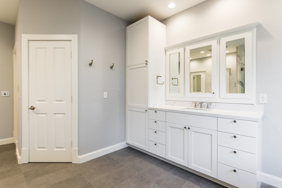 Mid-sized contemporary master bathroom in Dallas with white cabinets, a freestanding tub, an open shower, a one-piece toilet, white tile, stone slab, grey walls, an undermount sink, granite benchtops, grey floor, an open shower, white benchtops, an enclosed toilet and a double vanity.