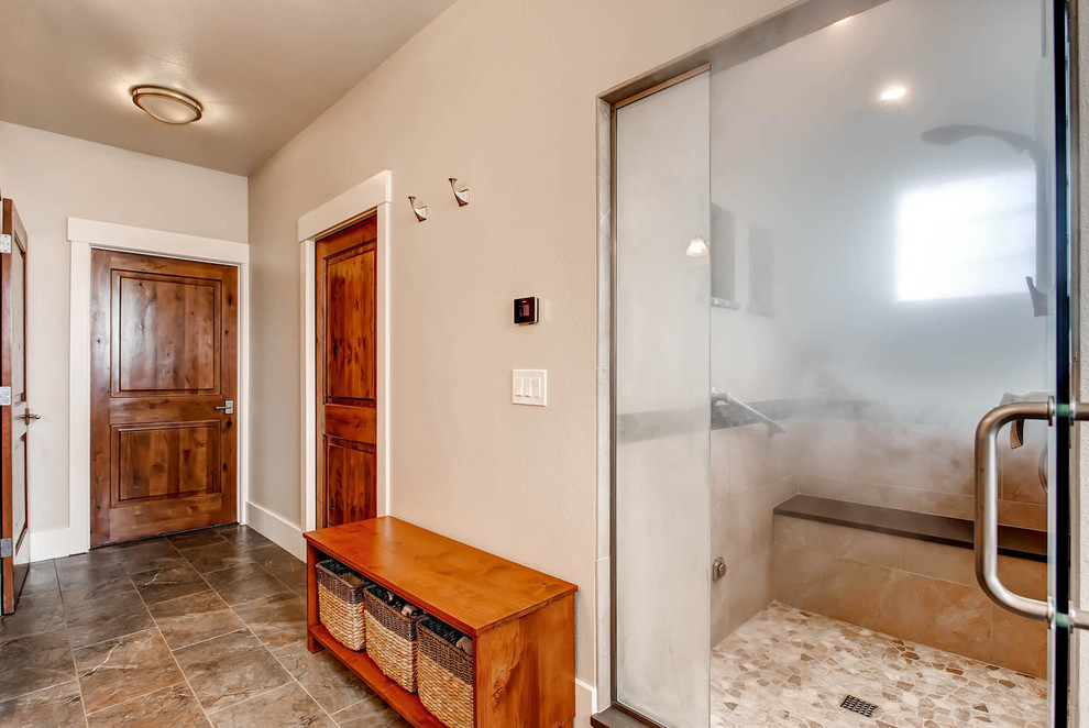 Corner bathtub - mid-sized transitional gray tile and porcelain tile porcelain tile corner bathtub idea in Denver with shaker cabinets, medium tone wood cabinets, a one-piece toilet, gray walls, an undermount sink and solid surface countertops