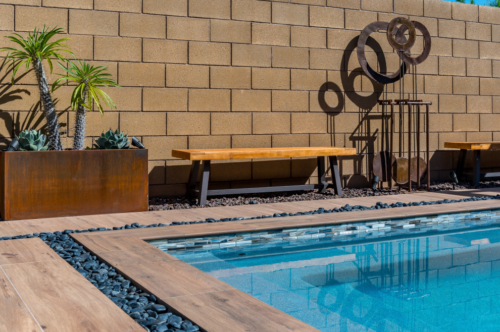 Pool - small backyard tile and rectangular pool idea in Phoenix