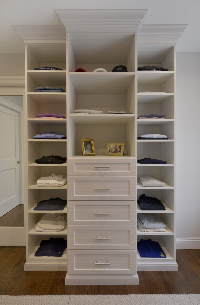 Design ideas for a large contemporary gender-neutral walk-in wardrobe in New York with shaker cabinets, white cabinets and dark hardwood floors.