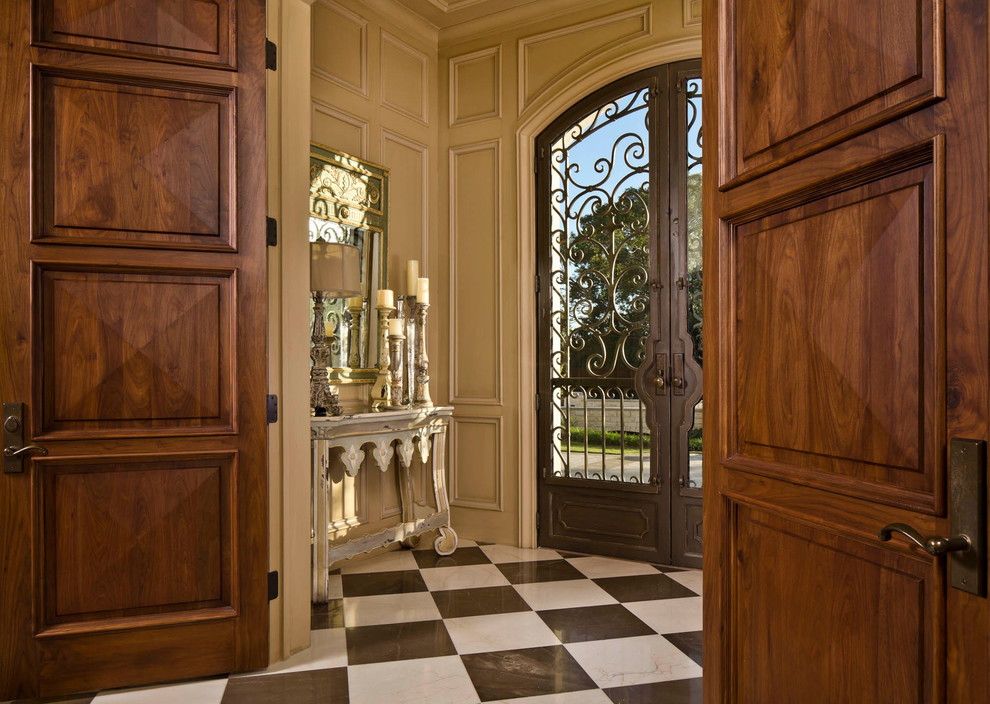 Traditional entryway in Dallas with a double front door and a metal front door.