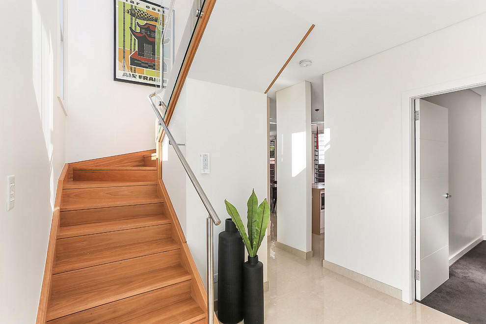 Photo of a mid-sized contemporary wood u-shaped staircase in Sydney with wood risers.