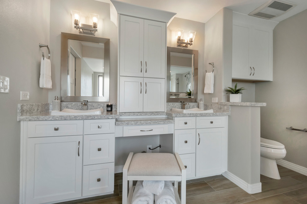 Large transitional master bathroom in Phoenix with shaker cabinets, white cabinets, a drop-in tub, an open shower, gray tile, porcelain tile, grey walls, porcelain floors, a drop-in sink, engineered quartz benchtops, brown floor, an open shower and grey benchtops.