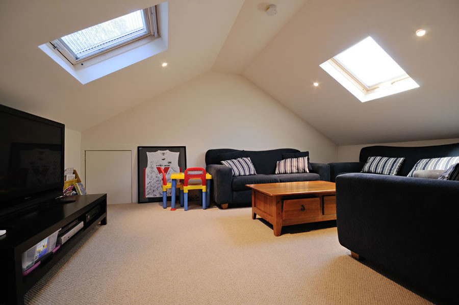 Photo of a small contemporary loft-style family room in Sydney with beige walls, carpet, no fireplace and beige floor.