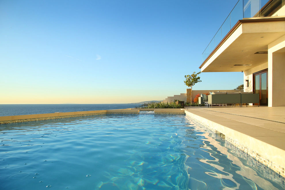 Inspiration for a mid-sized backyard rectangular pool remodel in Orange County