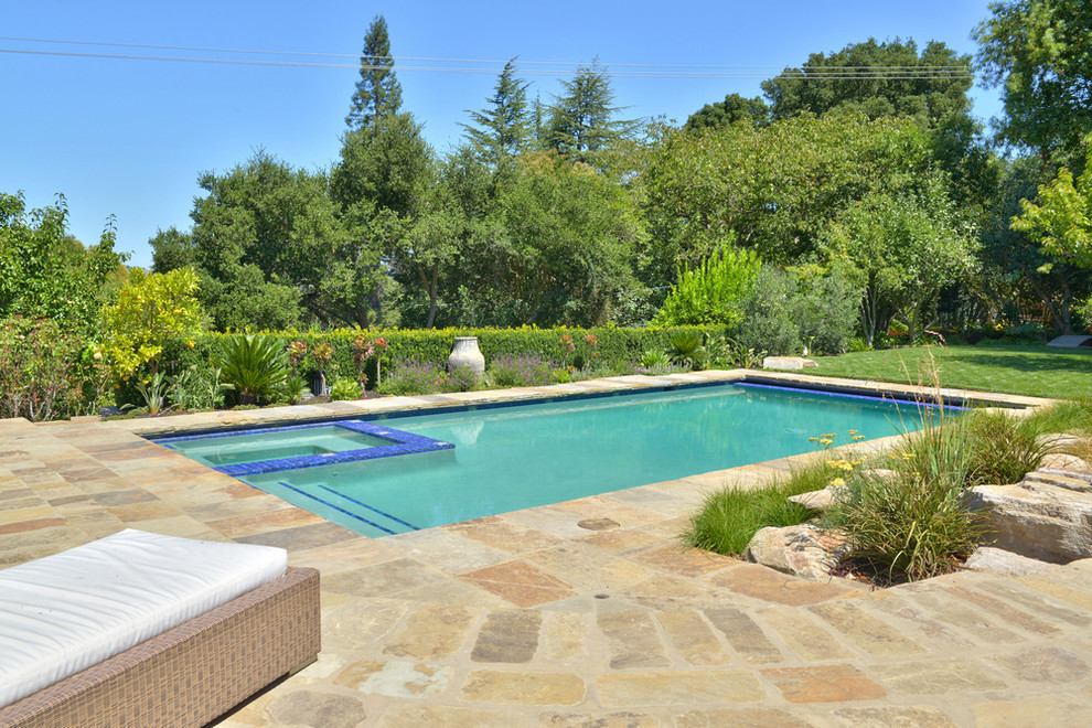 Design ideas for a mid-sized mediterranean backyard rectangular lap pool in San Francisco with natural stone pavers.