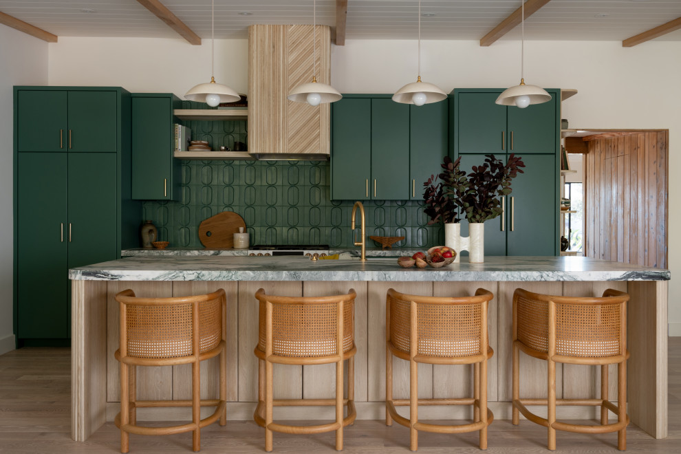 Inspiration for a mid-century modern galley light wood floor, beige floor, exposed beam, shiplap ceiling and vaulted ceiling kitchen remodel in San Diego with flat-panel cabinets, green cabinets, green backsplash, paneled appliances, an island and gray countertops