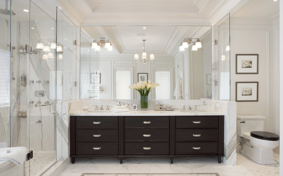 Inspiration for a transitional master bathroom in New York with recessed-panel cabinets, dark wood cabinets, a corner shower, a one-piece toilet, white walls and an undermount sink.