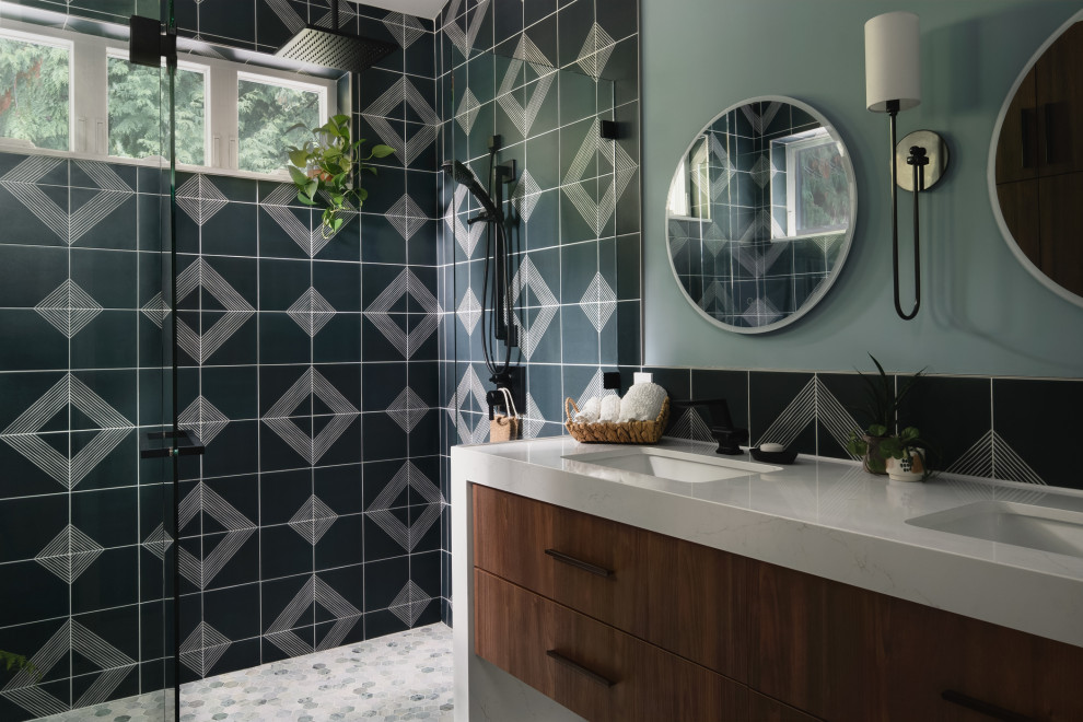 Inspiration for a contemporary bathroom in Seattle with flat-panel cabinets, medium wood cabinets, an alcove shower, blue walls, mosaic tile floors, an undermount sink, grey floor, a hinged shower door, white benchtops, a double vanity and a floating vanity.