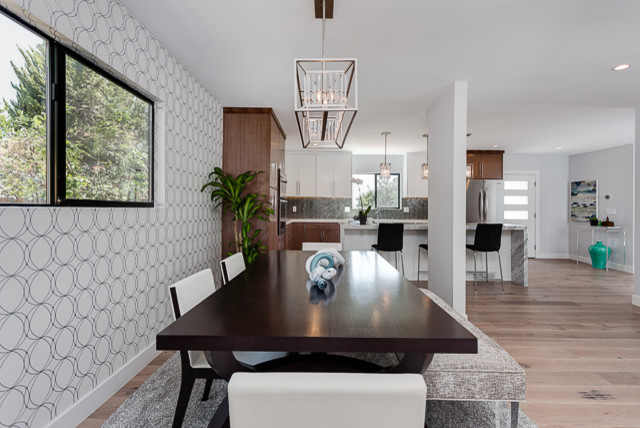 Inspiration for a mid-sized modern kitchen/dining combo in Los Angeles with white walls, no fireplace and light hardwood floors.