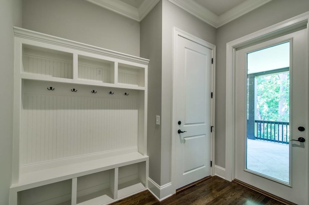 Inspiration for a mid-sized transitional dark wood floor and brown floor mudroom remodel with gray walls and a glass front door