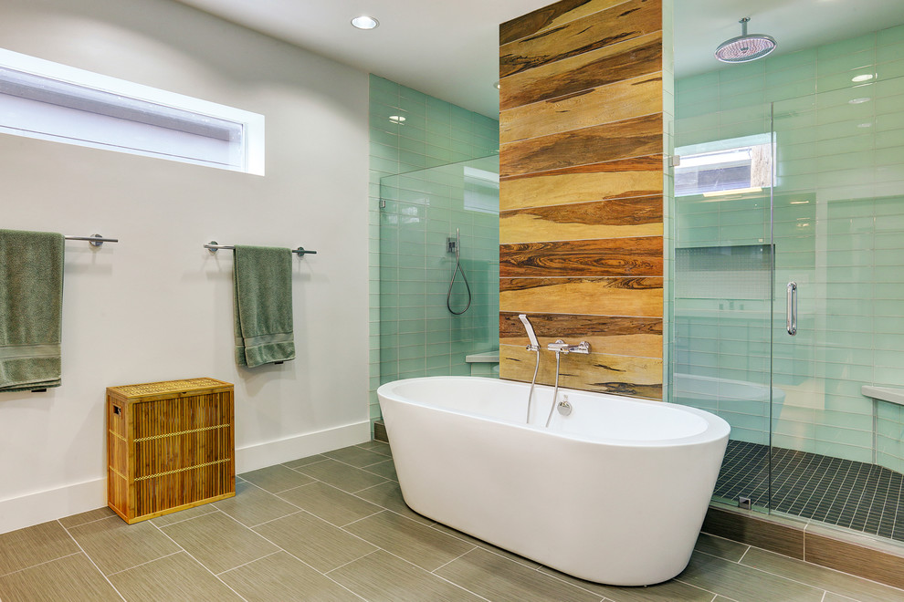 Design ideas for a large contemporary master bathroom in Houston with a drop-in sink, flat-panel cabinets, grey cabinets, marble benchtops, a freestanding tub, a double shower, a one-piece toilet, green tile, glass tile, white walls and ceramic floors.