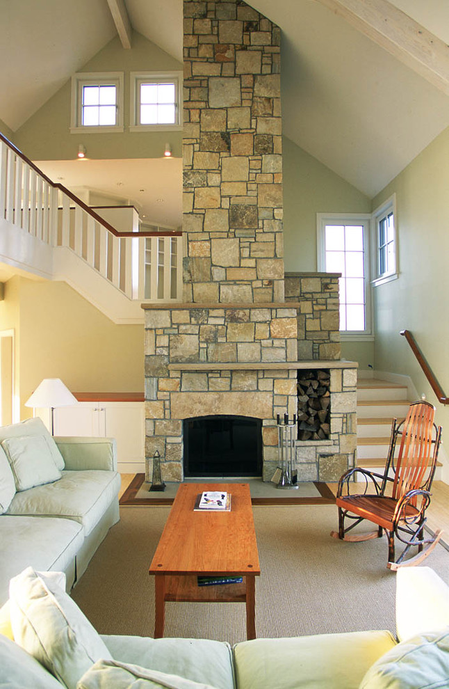 Photo of a beach style living room in Boston with a stone fireplace surround.