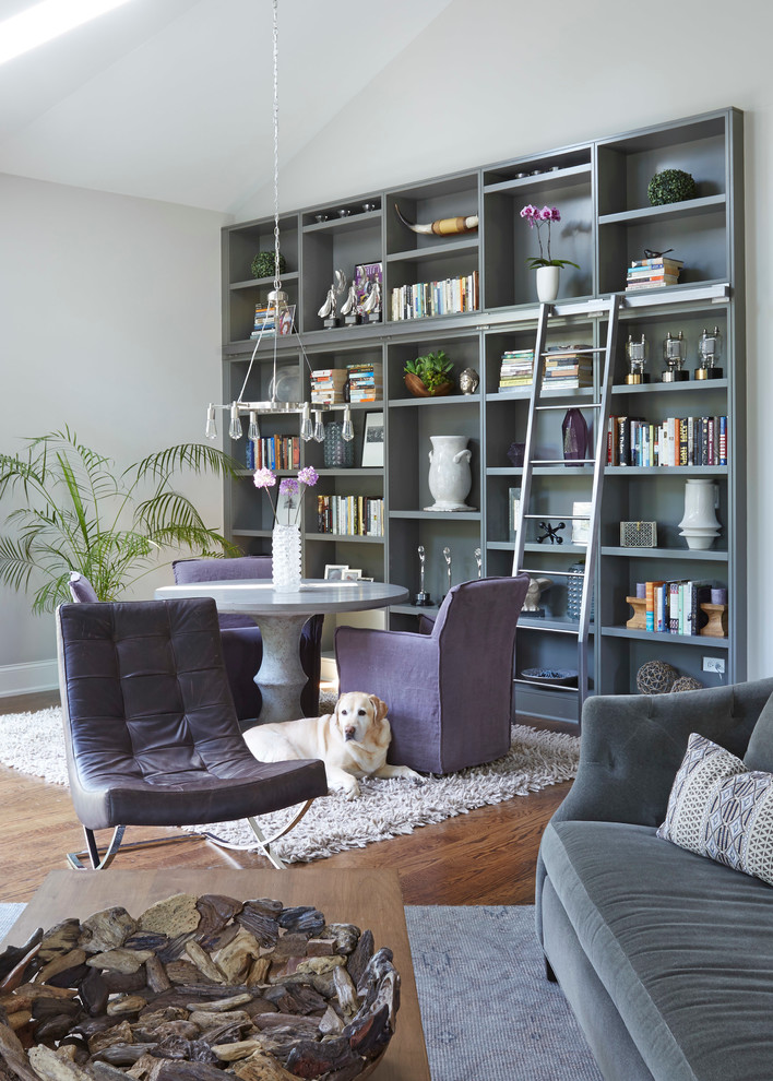 Photo of an expansive contemporary loft-style living room in Chicago with a library, grey walls, dark hardwood floors, a standard fireplace, a stone fireplace surround and a wall-mounted tv.
