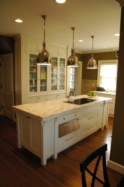 Photo of a traditional u-shaped separate kitchen in Indianapolis with an undermount sink, recessed-panel cabinets, white cabinets and stainless steel appliances.