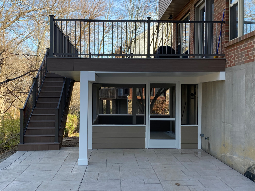 This is an example of a large traditional back first floor metal railing terrace in Cincinnati with a roof extension.