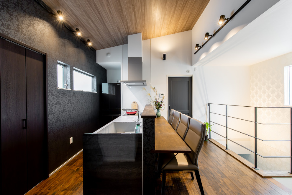 Design ideas for a small kitchen/dining combo in Osaka with black walls, dark hardwood floors, wallpaper and wallpaper.