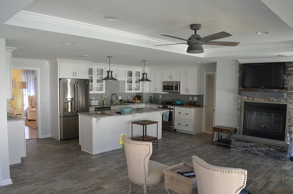 Mid-sized transitional l-shaped dark wood floor and brown floor eat-in kitchen photo with an undermount sink, shaker cabinets, white cabinets, granite countertops, gray backsplash, porcelain backsplash, stainless steel appliances and an island
