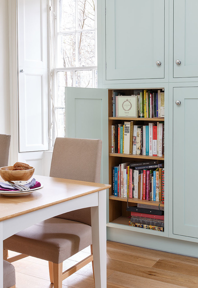Design ideas for a country l-shaped kitchen/diner in Edinburgh with shaker cabinets, blue cabinets, blue splashback, mosaic tiled splashback, light hardwood flooring and an island.