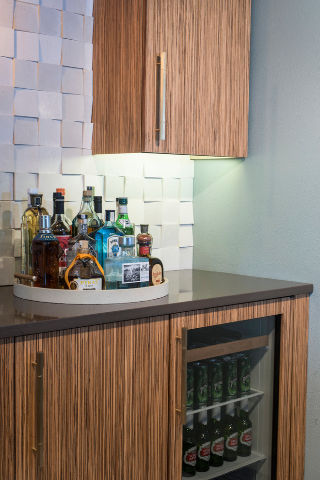 Design ideas for a contemporary single-wall seated home bar in Other with flat-panel cabinets, light wood cabinets, granite benchtops, beige splashback, stone tile splashback and porcelain floors.