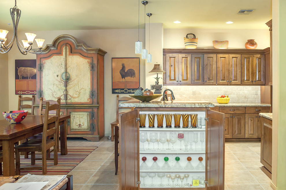 Example of a mid-sized transitional l-shaped porcelain tile and beige floor open concept kitchen design in Phoenix with an undermount sink, raised-panel cabinets, medium tone wood cabinets, granite countertops, beige backsplash, travertine backsplash and paneled appliances