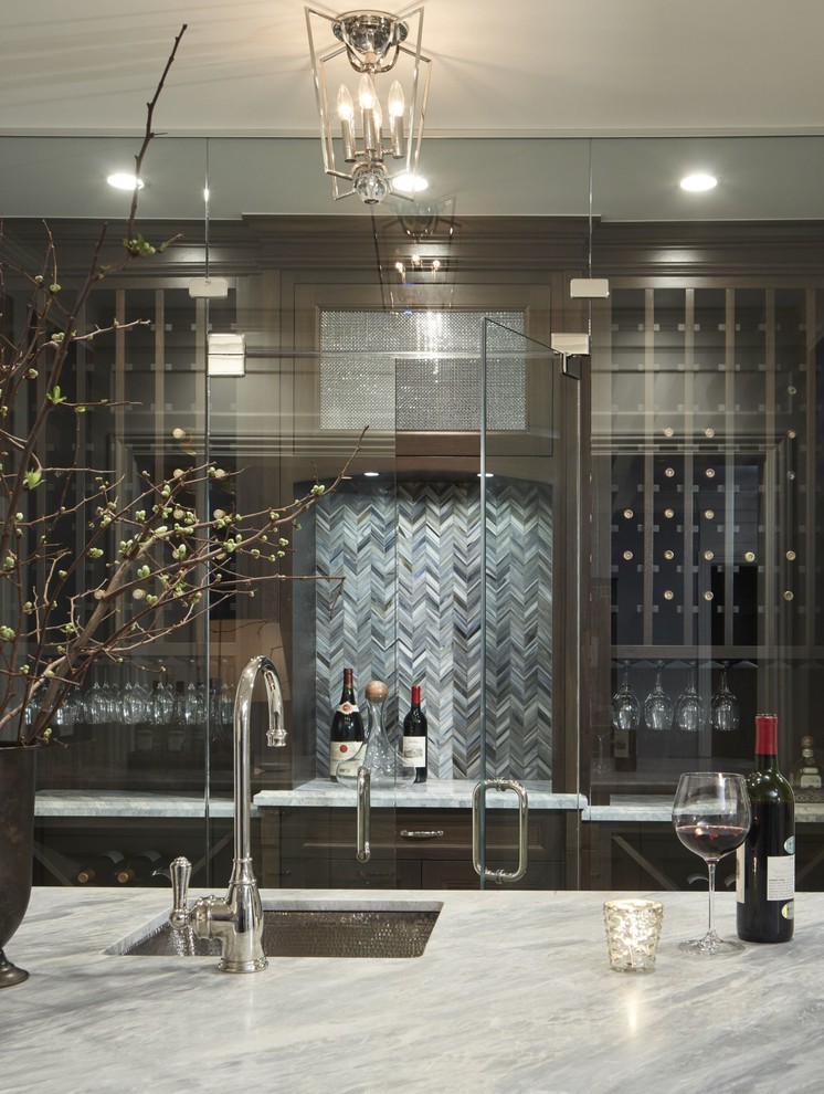 Large transitional galley wet bar in Chicago with an undermount sink, recessed-panel cabinets, brown cabinets, marble benchtops, grey splashback, glass tile splashback and porcelain floors.
