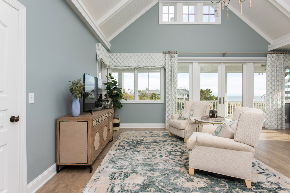 Large beach style master bedroom in Other with blue walls and vaulted.