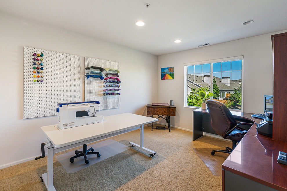 Inspiration for a large home office in Seattle with carpet, a freestanding desk and beige floor.
