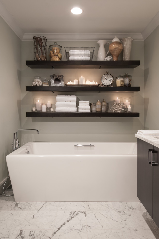 This is an example of a mid-sized transitional master bathroom in St Louis with an undermount sink, flat-panel cabinets, marble benchtops, a freestanding tub, an alcove shower, white tile, stone tile, grey walls, marble floors and dark wood cabinets.