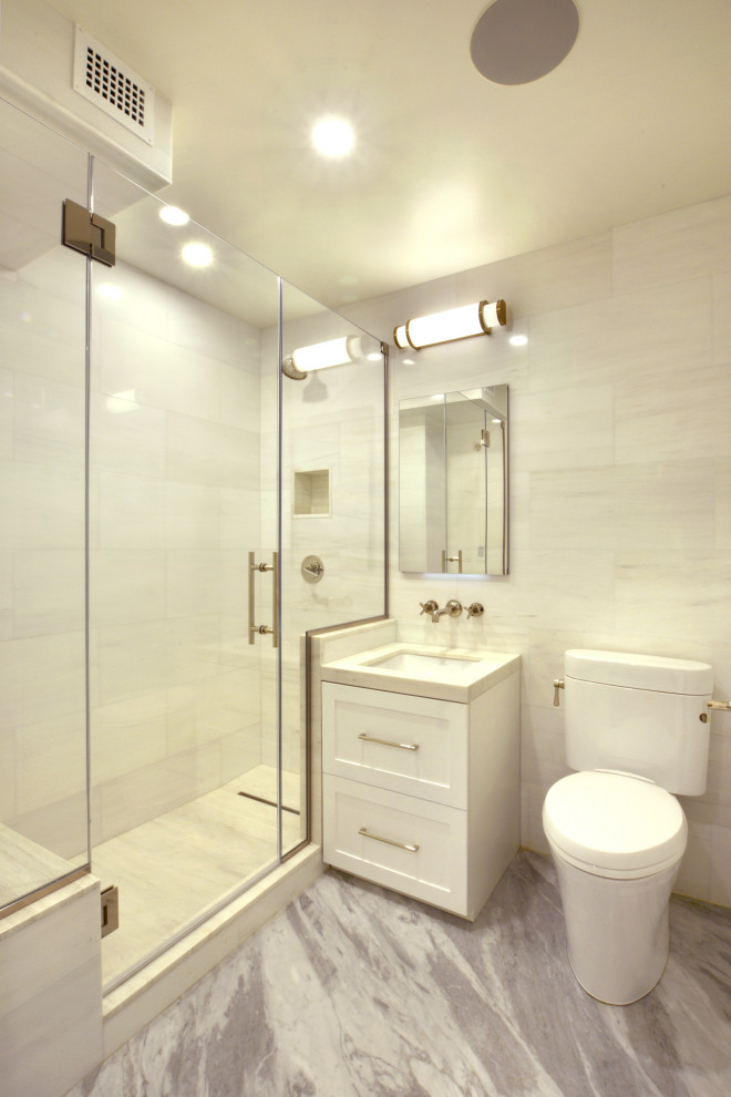 This is an example of a large transitional kids bathroom in New York with shaker cabinets, white cabinets, ceramic tile, marble floors, marble benchtops, a single vanity and a freestanding vanity.