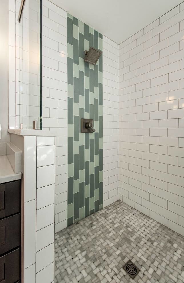 This is an example of a mid-sized contemporary master bathroom in Los Angeles with shaker cabinets, dark wood cabinets, a curbless shower, a one-piece toilet, multi-coloured tile, porcelain tile, beige walls, plywood floors, an integrated sink, solid surface benchtops, beige floor, a sliding shower screen and white benchtops.