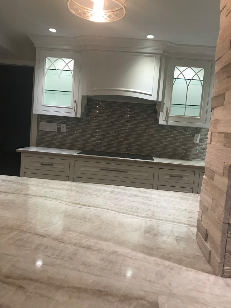 Inspiration for a mid-sized transitional kitchen remodel in Miami with recessed-panel cabinets, gray cabinets, gray backsplash, matchstick tile backsplash and paneled appliances