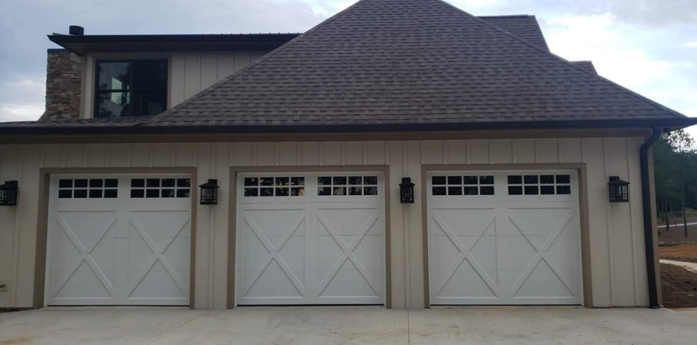 Design ideas for a large rural attached garage in St Louis with three or more cars.