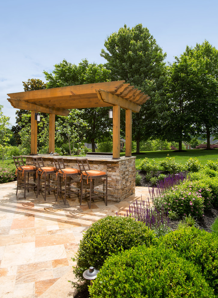 Transitional backyard patio in DC Metro with an outdoor kitchen, natural stone pavers and a pergola.