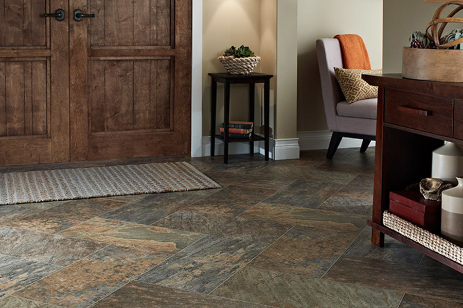 Inspiration for a small rustic vinyl floor foyer remodel in Indianapolis with beige walls and a dark wood front door