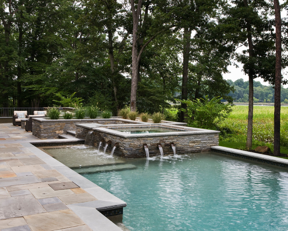 Mid-sized contemporary backyard rectangular lap pool in Philadelphia with a water feature and tile.