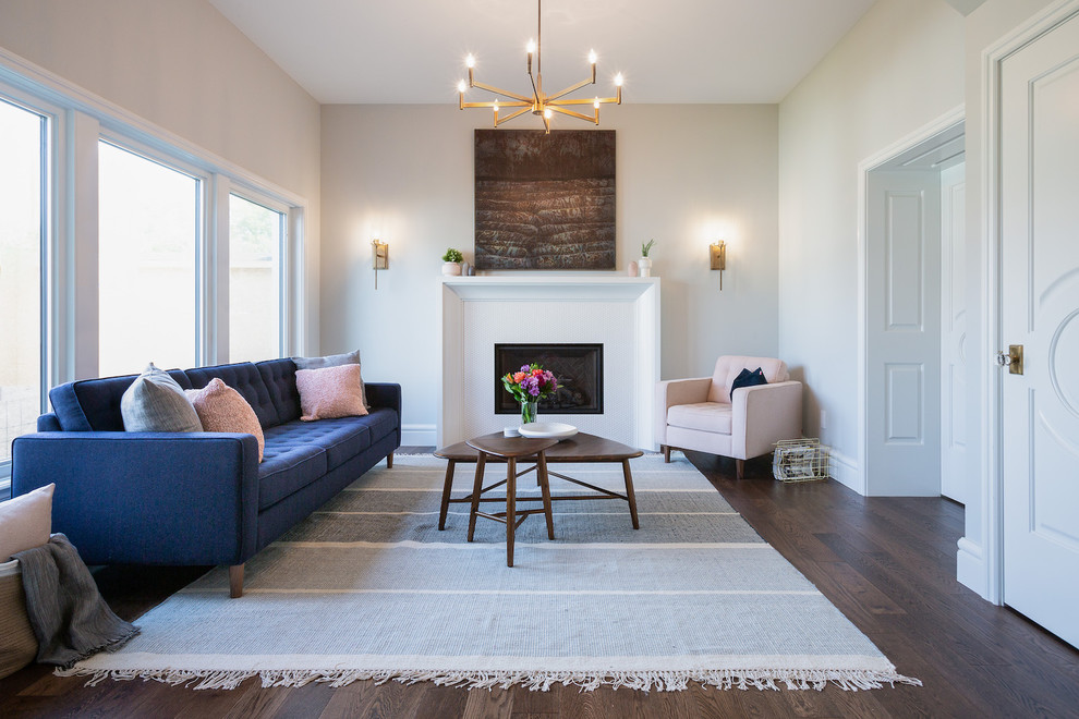 Inspiration for a mid-sized transitional formal enclosed living room in Other with white walls, a standard fireplace, brown floor and dark hardwood floors.